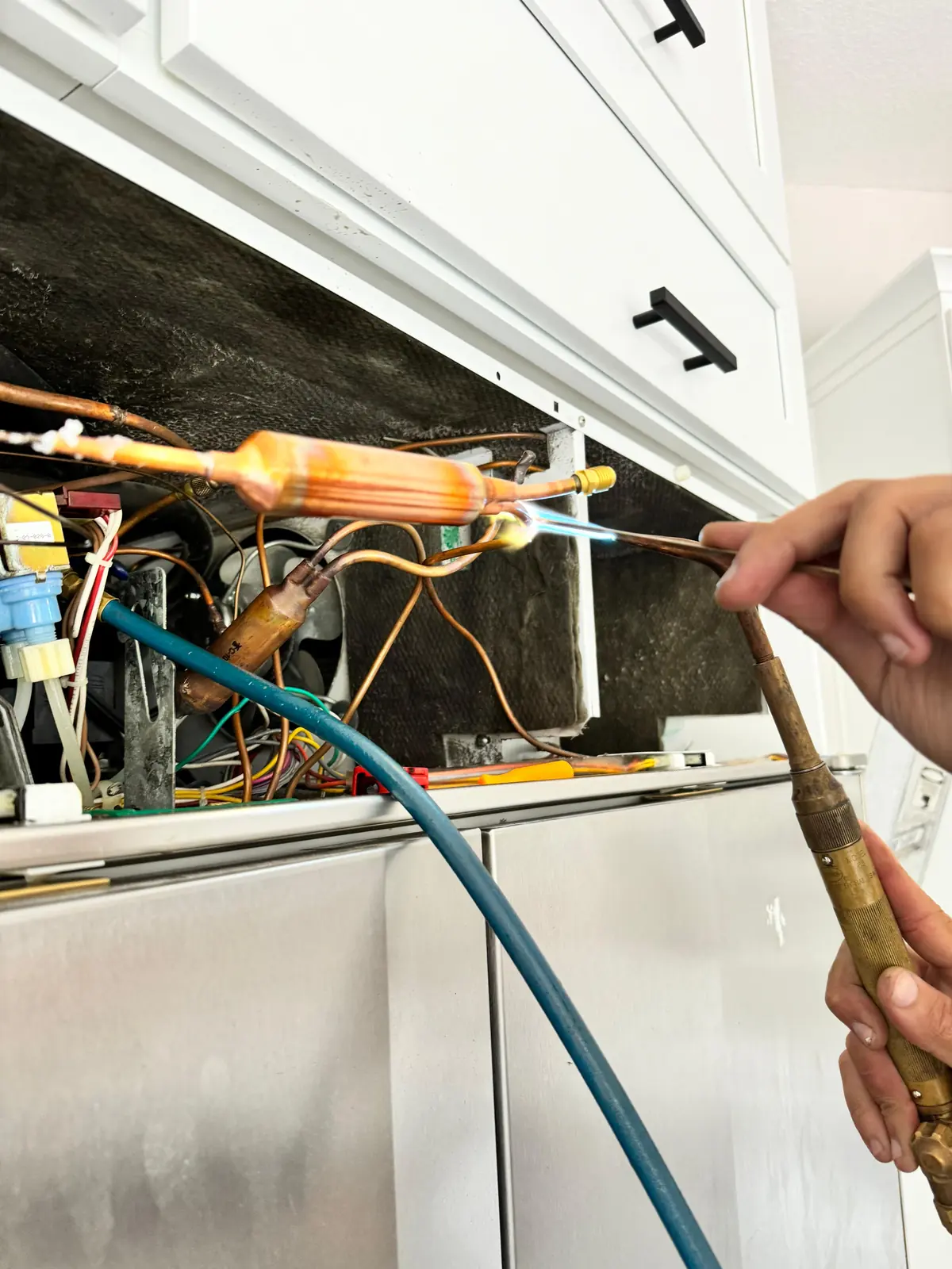 Close-up of a torch brazing refrigerant tubing